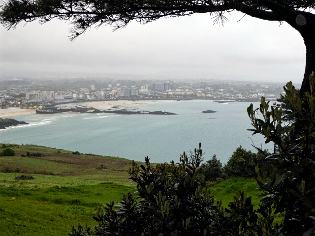Looking back at Hamdeok Beach on a dull wet day