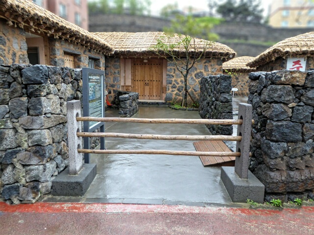 Reconstructed Jeju merchants inn of old - stone walls, straw roof - 3 poles across means we are not at home, please keep out