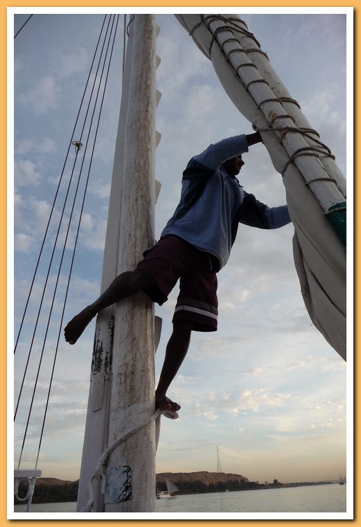Crewman adjusting the sail