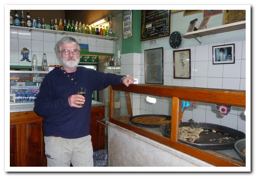 Pirilo is a tiny bar without seats, tables or plates selling 3 different types of pizza by the slice (a slice of pizza and a glass of wine costs $2).  It has been there since 1930 and is usually packed.